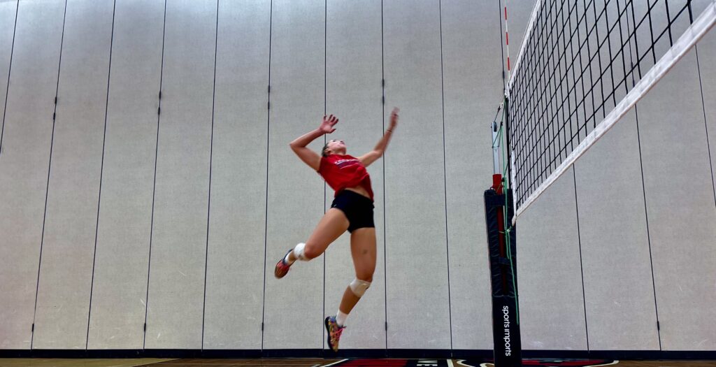 A female volleyball player is preparing to spike the ball - edited photo.